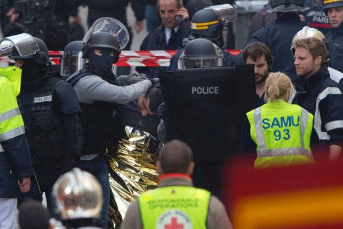 Police officers detain a man in Saint-Denis on November 18.