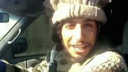 This undated image taken from a Militant Website on Monday, Nov.16, 2015, shows Belgian Abdelhamid Abaaoud. A senior police official said on Wednesday, Nov. 18, 2015, that he believed the Belgian Islamic State militant was inside an apartment in the Paris suburb of Saint-Denis with other heavily armed people. A French official said Monday that Abdelhamid Abaaoud is the suspected mastermind of the Paris attacks was also linked to thwarted train and church attacks. (Militant video via AP)