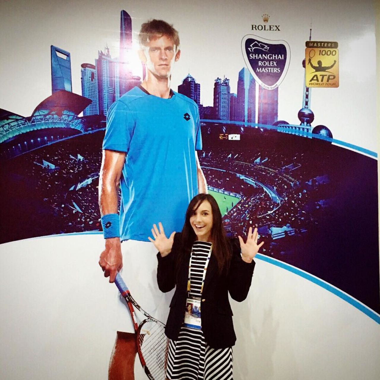 The 29-year-old stands before a giant billboard of her husband -- who in real-life is a towering 6 foot 8 inches tall.