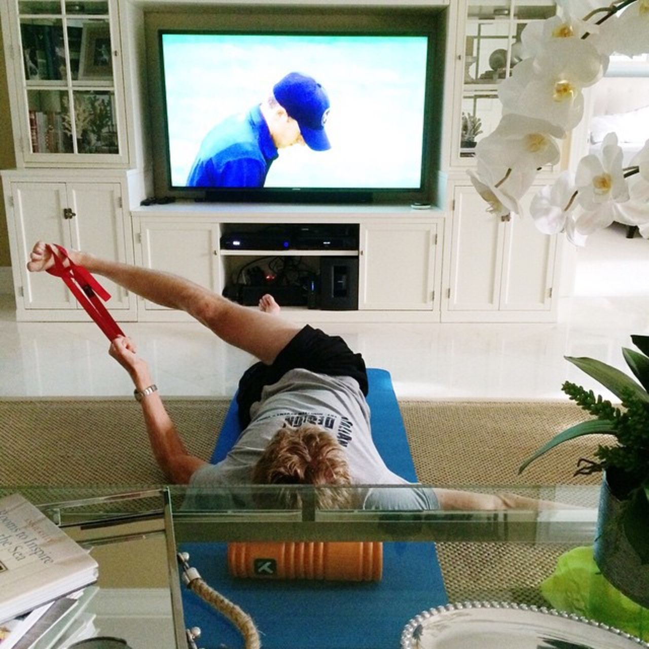 At home in Miami, Kevin works out while matching the Masters golf tournament on TV, in this snap also from Kelsey's Instagram account.