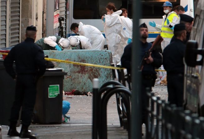 A forensics team searches for evidence outside the building on November 18.