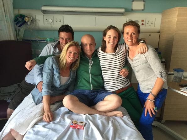 The 27-year-old poses with friends during his chemotherapy treatment.