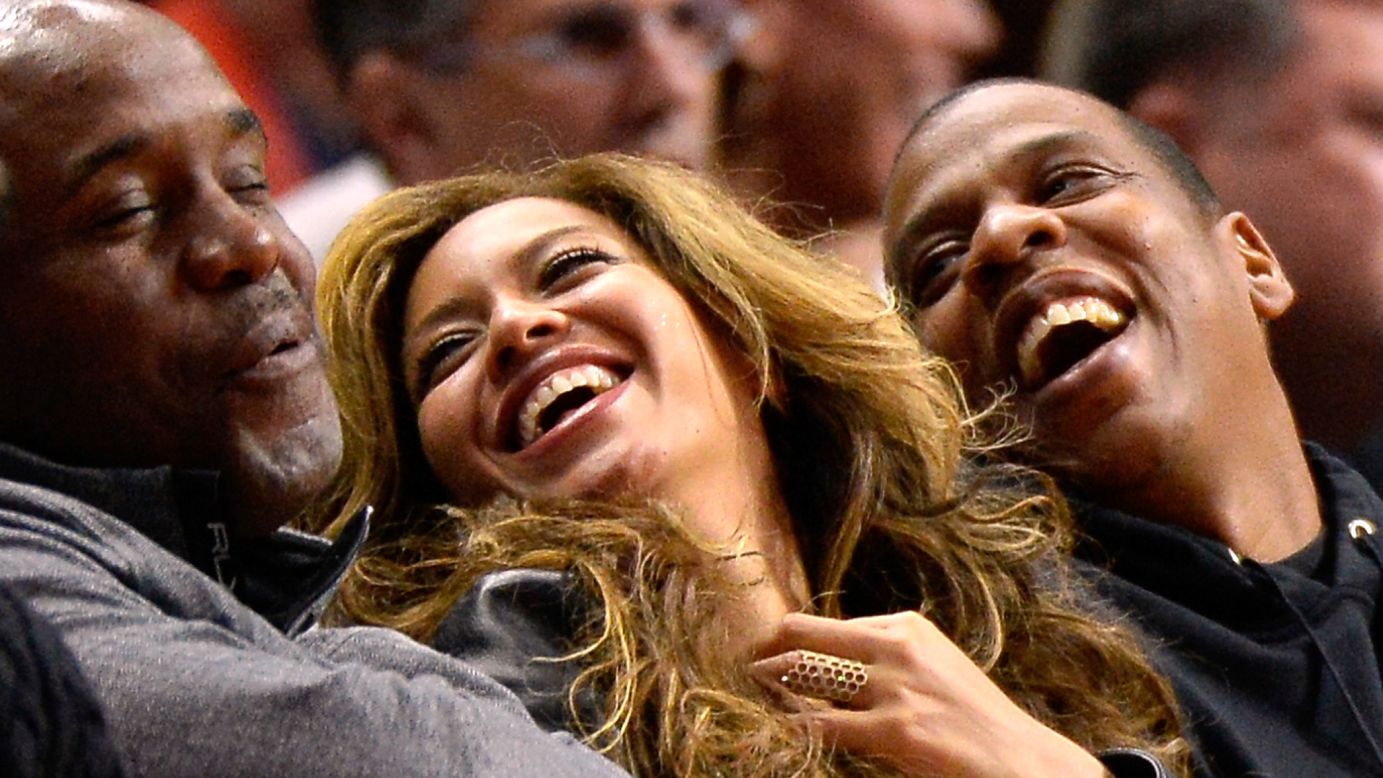 Singer Beyonce and her husband, rapper Jay Z, laugh while sitting courtside at a Los Angeles Clippers basketball game on Thursday, January 22.