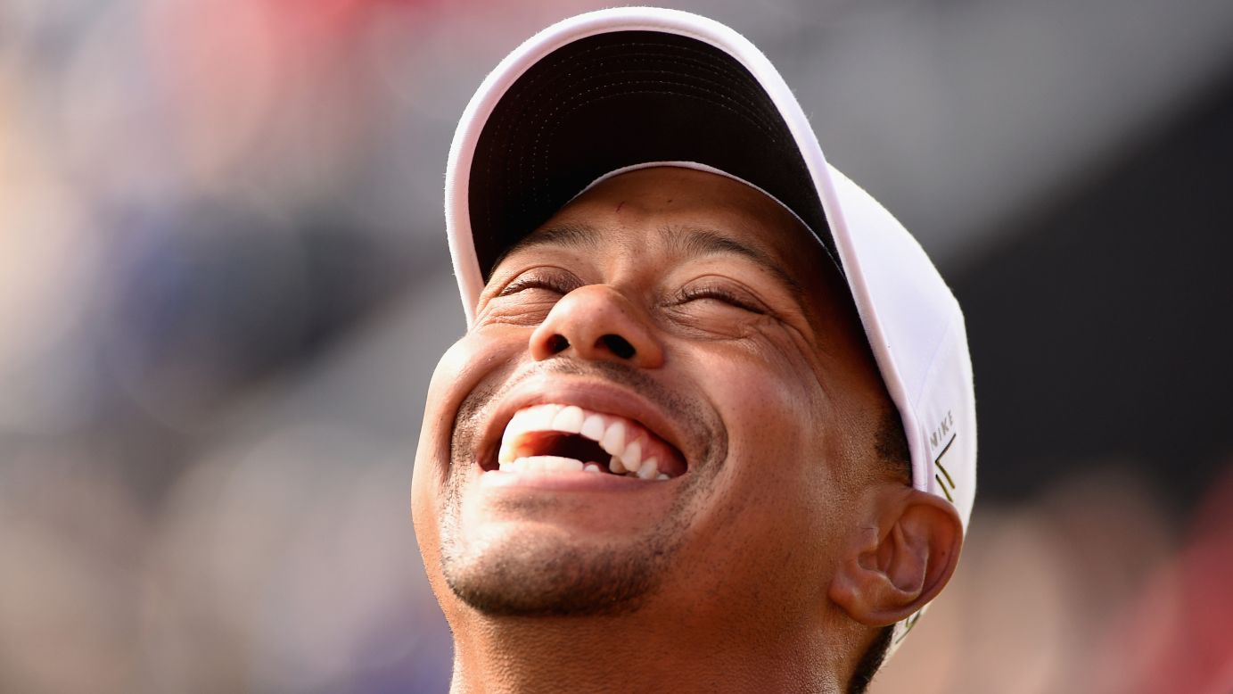 Tiger Woods laughs during the Champion Golfers' Challenge, a four-hole exhibition event held before the British Open on Wednesday, July 25.