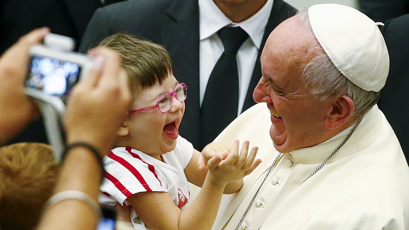 Pope Francis laughs with a child at the Vatican on Saturday, September 5.