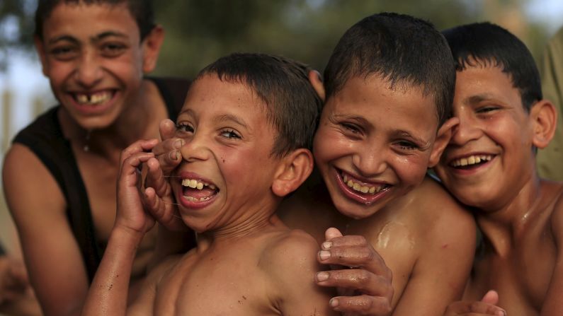 Boys play together after jumping in the Nile River to cool off Wednesday, May 27, in Cairo.