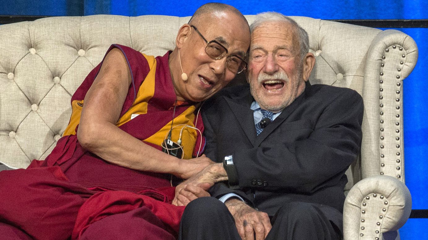 The Dalai Lama and oceanographer Walter Munk share a moment during a discussion about climate change Monday, July 6, at the University of California-Irvine.
