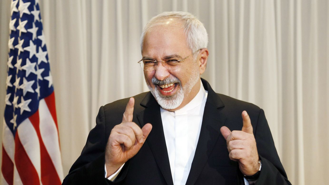 Iranian Foreign Minister Mohammad Javad Zarif jokes with reporters in Geneva, Switzerland, before meeting with U.S. Secretary of State John Kerry on Wednesday, January 14.