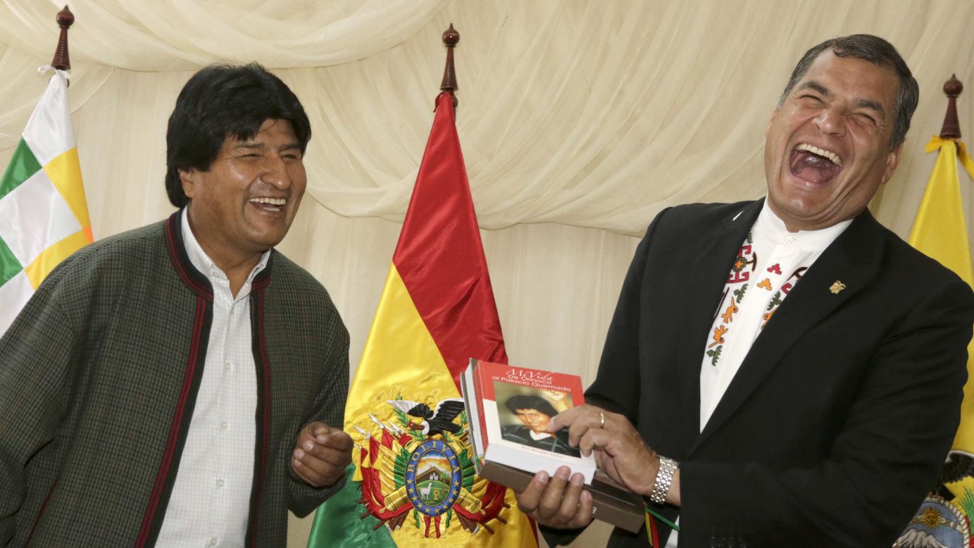 Ecuadorian President Rafael Correa, right, jokes with Bolivian President Evo Morales during a meeting in Tiquipaya, Bolivia, on Monday, October 12.
