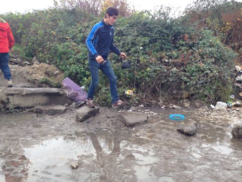 The muddy tracks in the camp are now turning into lakes. People hop across as best they can. Few wear boots or waterproofs; many only have on sandals.
