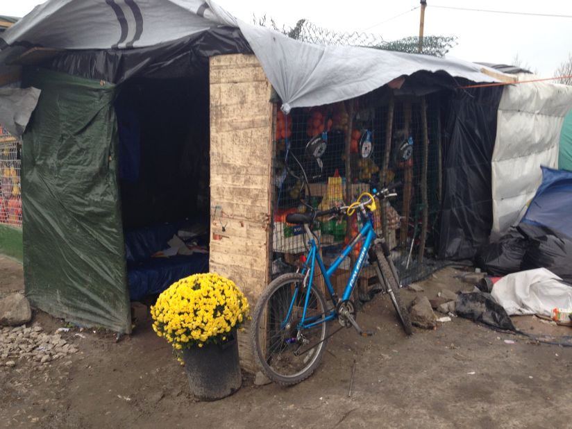 Shops and restaurants set up by migrants in the camp serve chips, chicken and soft drinks. Like flowers, small luxuries juxtapose harshly with the grim reality inside the Jungle.