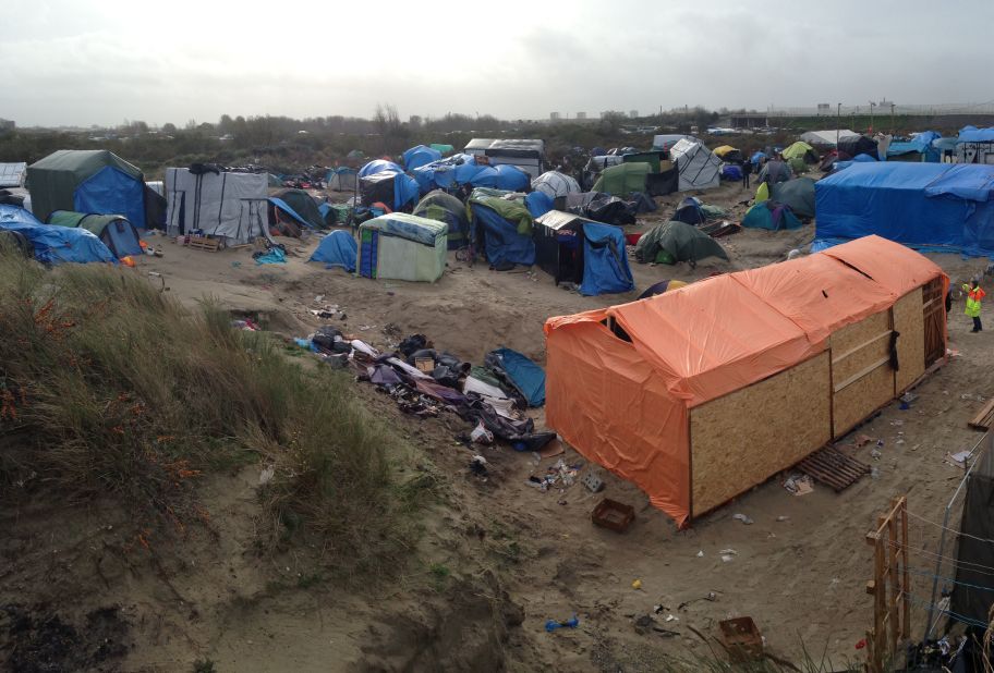 The camp itself is reached by a quiet country road that also heads to the nearby beach. It could be most places in France, except for the presence of several police vehicles and 10-feet high wire fences which surround nearby properties. 