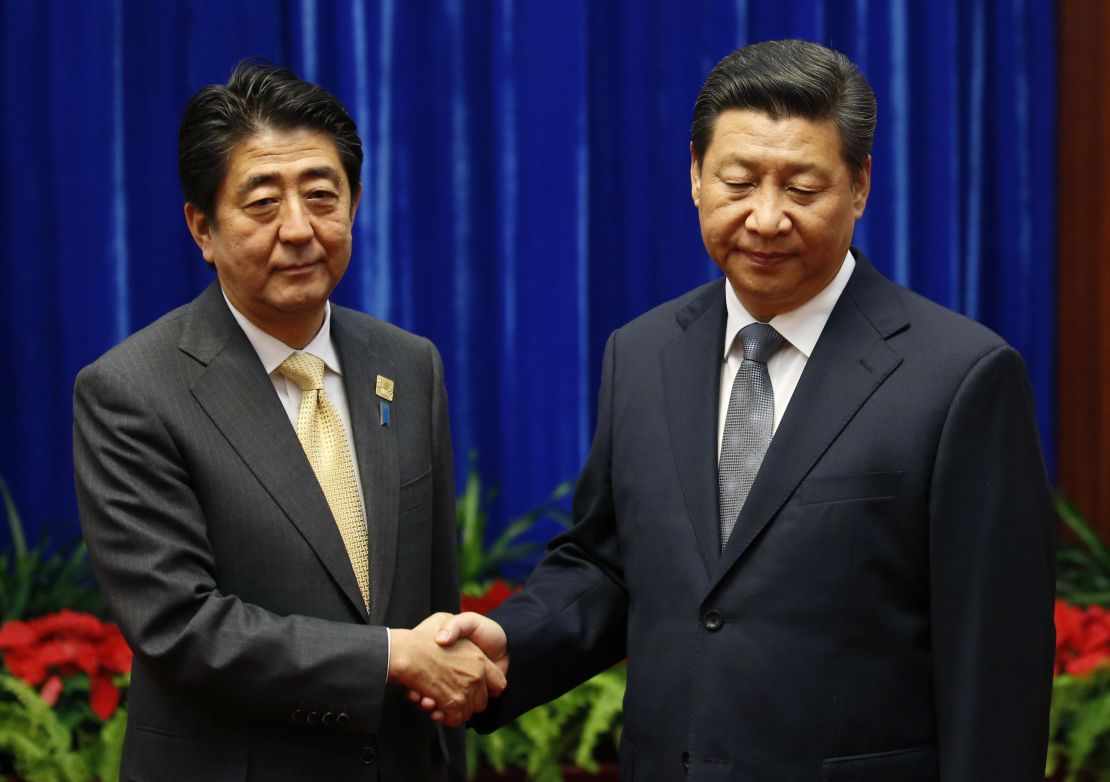 Japanese Prime Minister Shinzo Abe meets with Chinese President Xi Jinping at a 2014 forum.