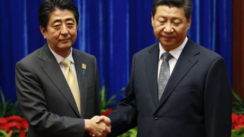 Japanese Prime Minister Shinzo Abe meets with Chinese President Xi Jinping at a 2014 forum.