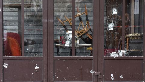 Bullet holes in the Café Bonne Bière storefront are a reminder of the carnage.