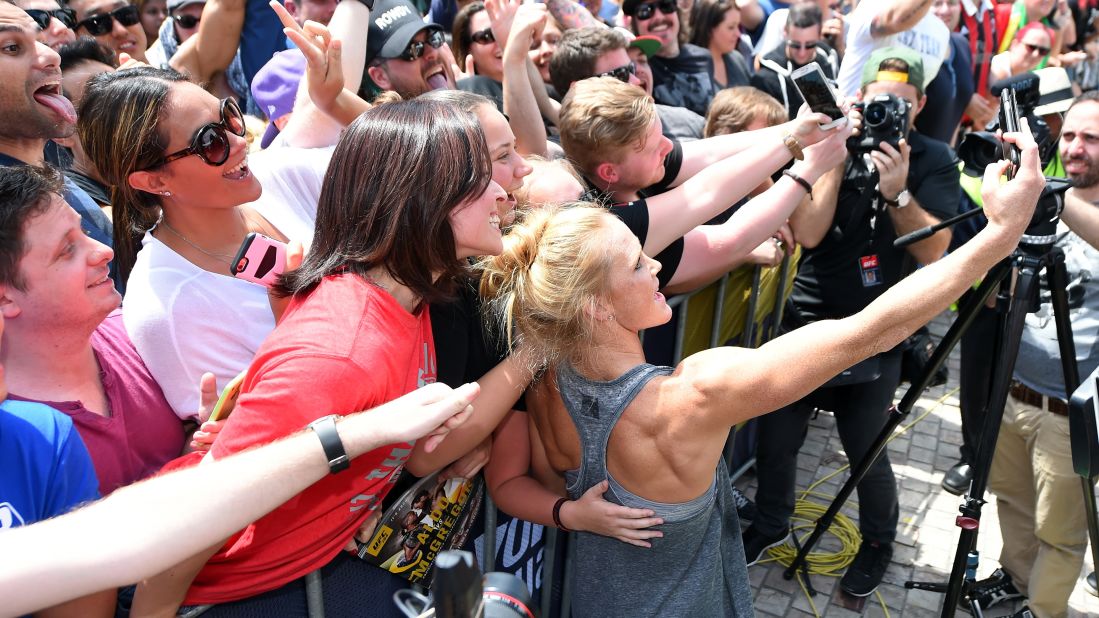 Holm takes a selfie with fans after an open prefight workout November 12 at Federation Square in Melbourne. In the past week, the little-known fighter has gained 1.4 million social media followers.