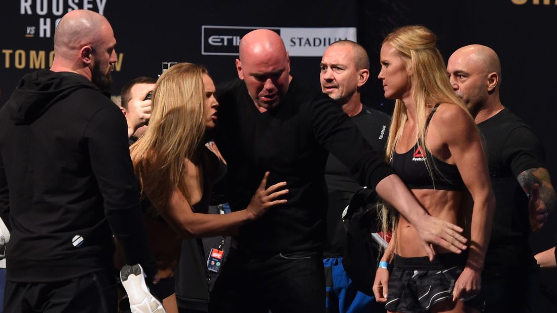 Rousey, left, and Holm face off during the weigh-in the day before their fight. Things got a little testy during their staredown, so UFC President Dana White, center, stepped in and defused the situation.