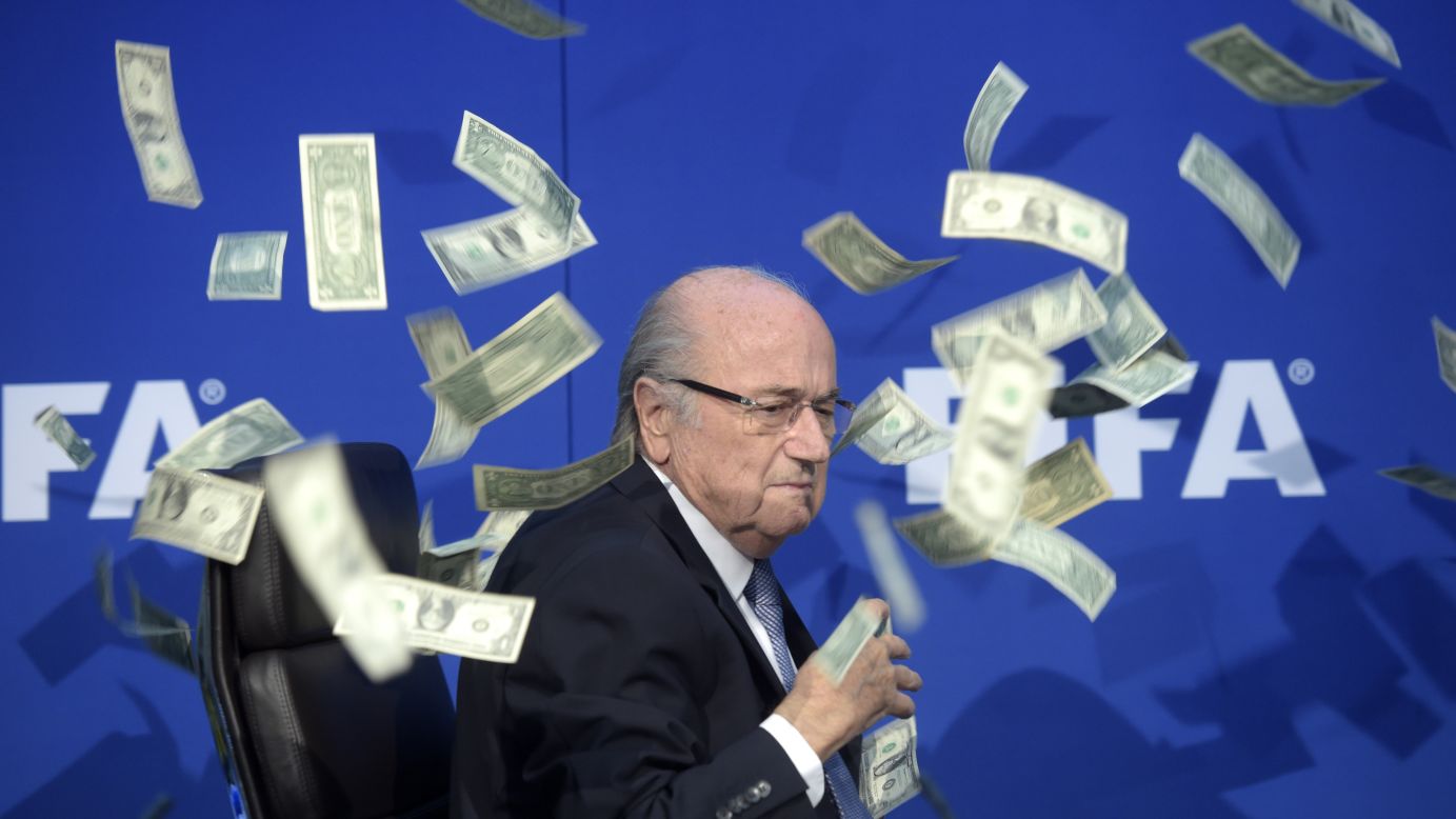 FIFA President Sepp Blatter <a href="http://www.cnn.com/2015/07/20/football/football-fifa-congress-platini/index.html" target="_blank">is showered by dollar bills</a> during a news conference in Zurich, Switzerland, on Monday, July 20. The money was thrown at Blatter by British comedian Simon Brodkin, who was then ushered away from the stage. Blatter has led soccer's governing body since 1998, but he decided to stand down as FIFA battles corruption scandals.