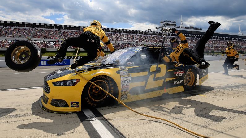 NASCAR driver Brad Keselowski accidentally crashes into two of his crew members during a Sprint Cup race Sunday, August 2, at Pennsylvania's Pocono Raceway. Neither crew member was hurt.