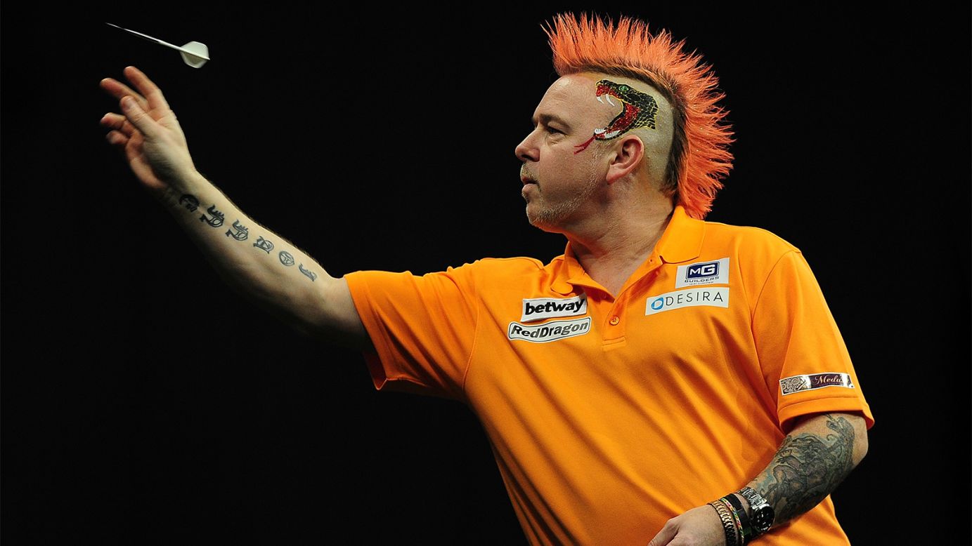 Colorful darts player Peter Wright competes in a Premier League Darts match Thursday, March 5, in Exeter, England.