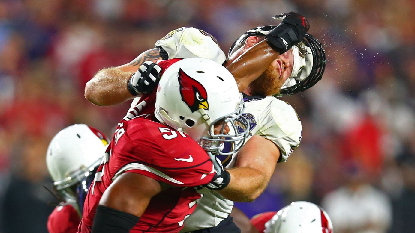 Baltimore Ravens guard Marshal Yanda has his helmet knocked off by Arizona linebacker Kevin Minter during an NFL game in Glendale, Arizona, on Monday, October 26.