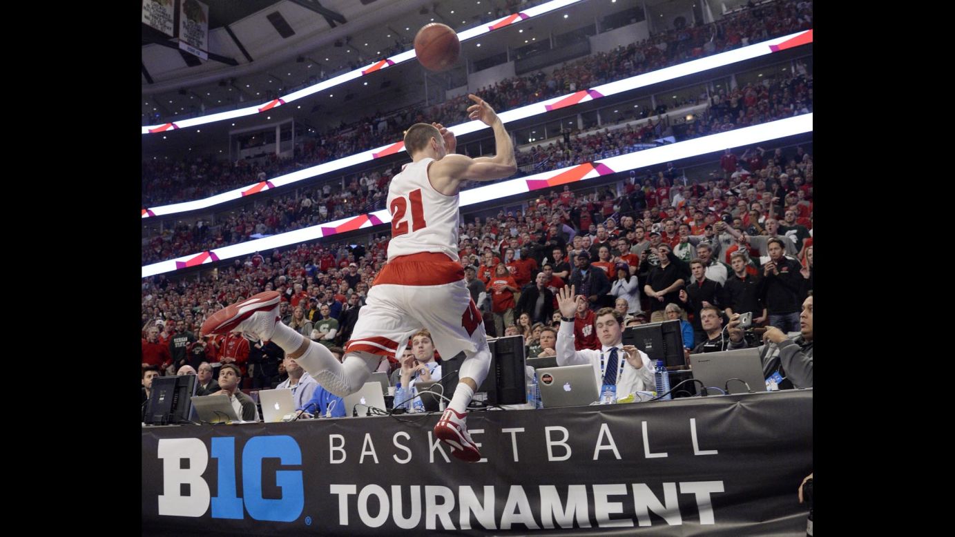 Wisconsin guard Josh Gasser dives into press row to keep a loose ball inbounds during the Big Ten championship game Sunday, March 15, in Chicago. The Badgers defeated Michigan State 80-69 and were later named a No. 1 seed in the NCAA Tournament.