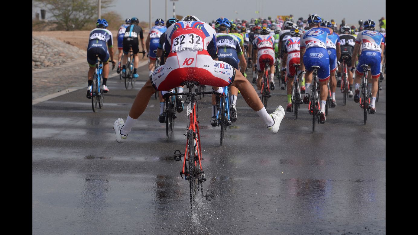 Italian cyclist Jacopo Guarnieri steers through a puddle Sunday, February 22, during the sixth stage of the Tour of Oman.