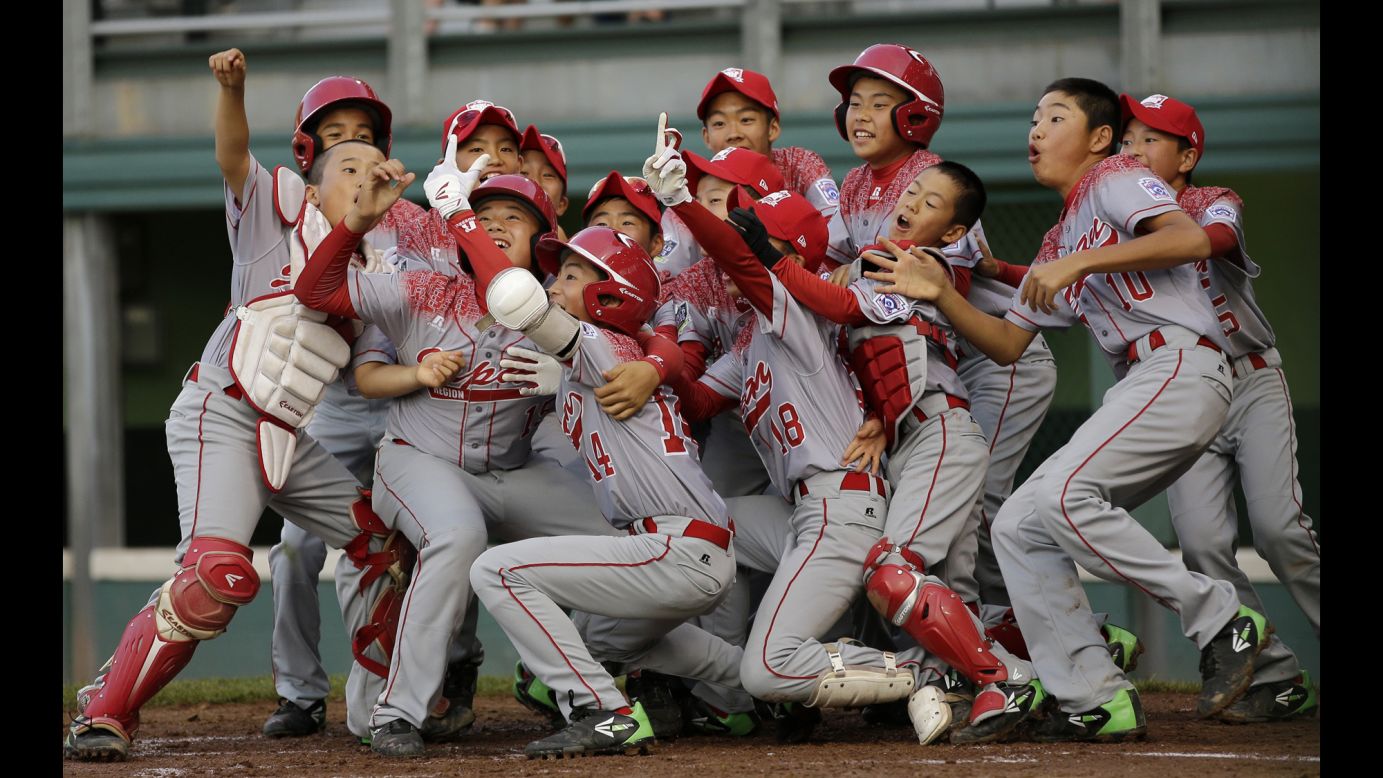 Players from Team Japan celebrate a home run with a fake selfie during the Little League World Series on Friday, August 21. They would go on to win the tournament.