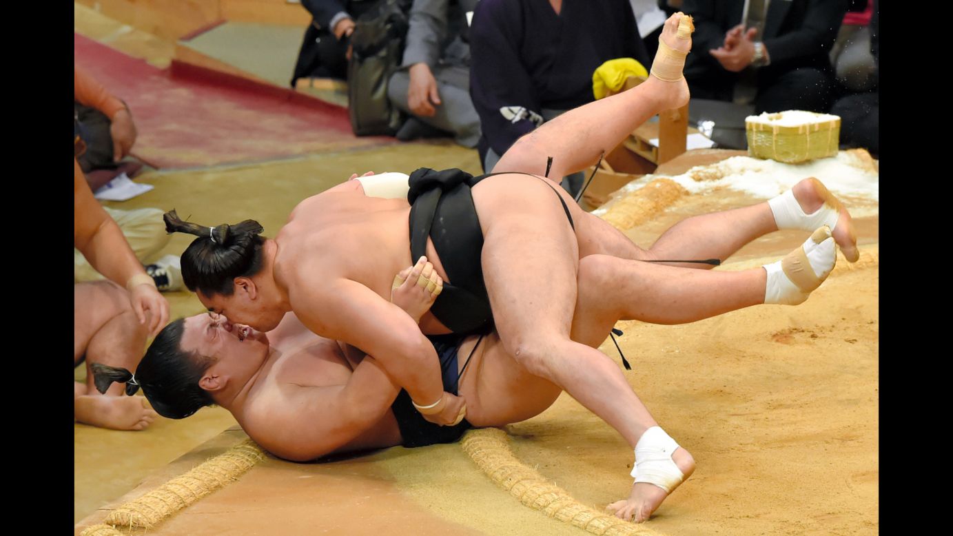 Mongolian sumo wrestler Harumafuji lands on Ikioi during a tournament in Fukuoka, Japan, on Monday, November 16.
