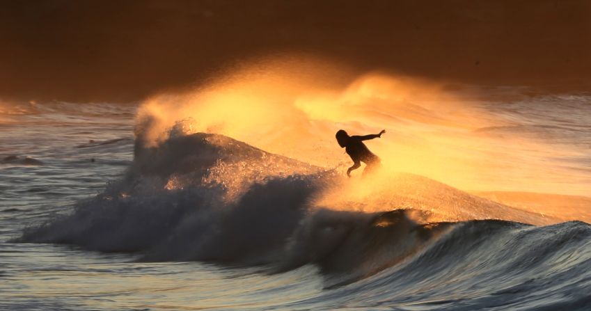 A surfer rides a wave in the Sydney suburb of Bronte on Thursday, August 6.