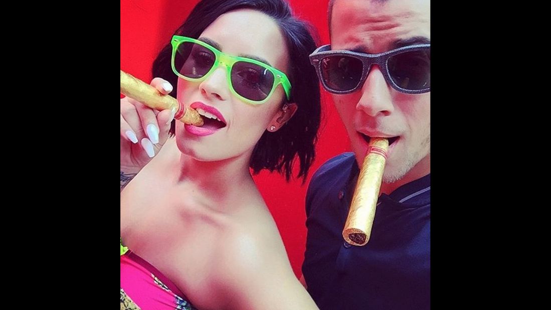 Singers Demi Lovato and Nick Jonas pose with 24-karat gold cigars in this selfie Lovato <a href="https://instagram.com/p/4r5ItAuKnv/" target="_blank" target="_blank">posted to Instagram</a> on Friday, July 3. "Nothing like one of your business partners/best friends showing up to support me and to celebrate #COOLFORTHESUMMER!!!!!!" Lovato said, referring to her latest single.