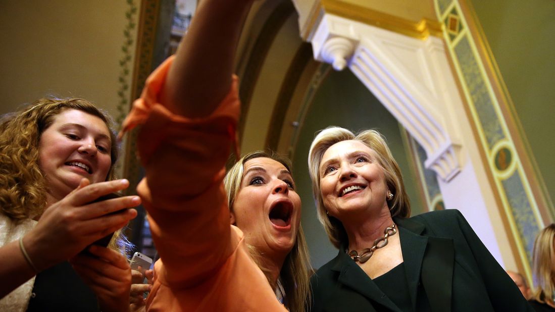 Democratic presidential candidate Hillary Clinton, right, stops for a selfie after meeting with members of the Iowa state legislature on Wednesday, April 15.