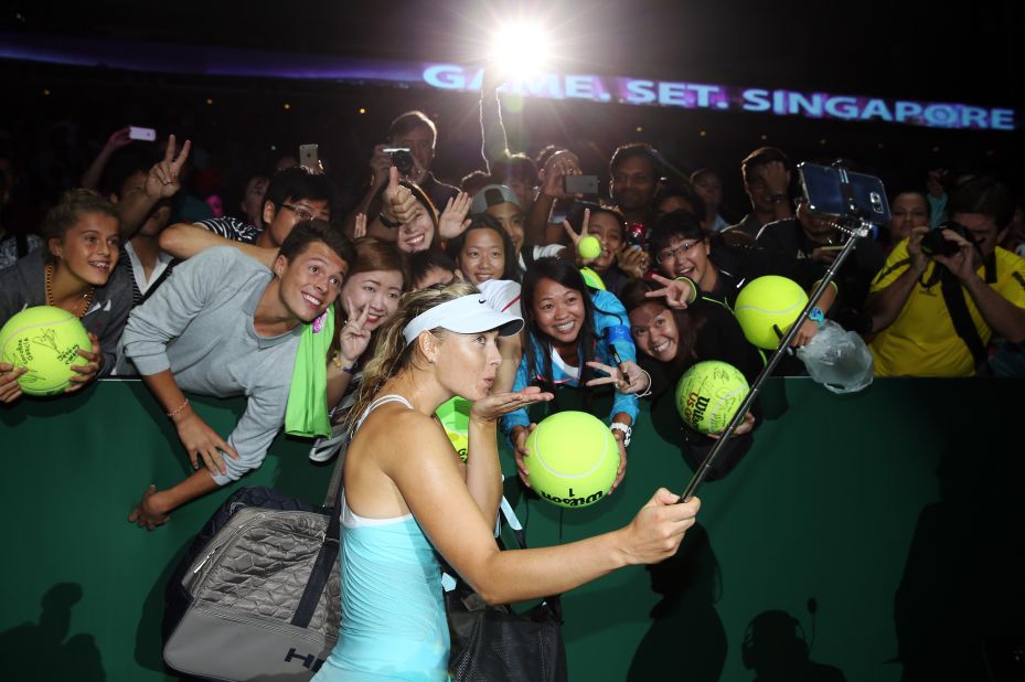 Tennis player Maria Sharapova holds a selfie stick after winning a match in Singapore on Sunday, October 25.