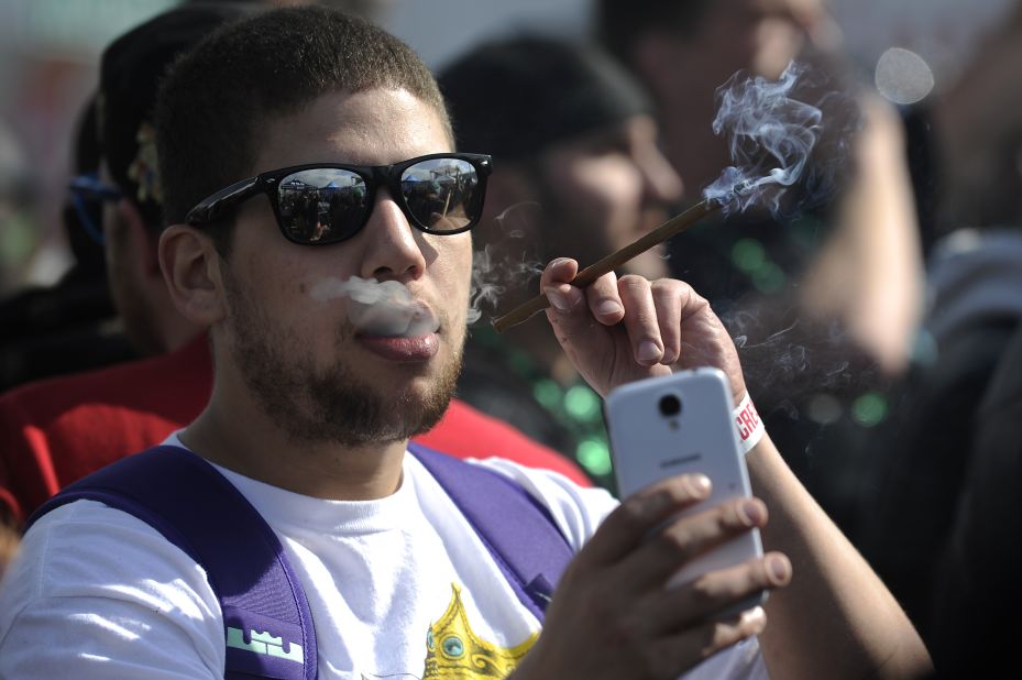 A man takes a selfie Sunday, April 19, as he smokes marijuana during the High Times Cannabis Cup, a trade show that took place in Denver.