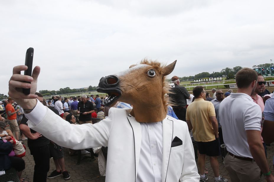 A spectator wearing a horse mask takes a selfie Saturday, June 6, before the Belmont Stakes in Elmont, New York. <a href="http://www.cnn.com/2015/06/01/sport/gallery/american-pharoah/index.html" target="_blank">American Pharoah</a> won the race and became <a href="http://www.cnn.com/2012/06/07/worldsport/gallery/triple-crown-winners/index.html" target="_blank">the first horse since 1978</a> to win the Triple Crown.