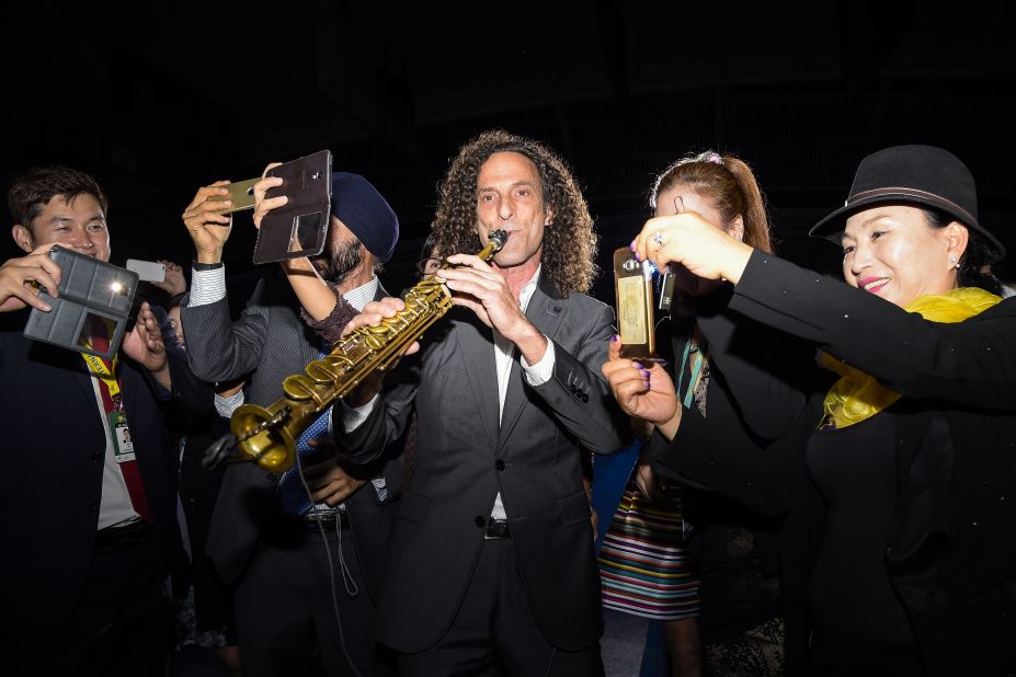 People in Incheon, South Korea, take selfies with recording artist Kenny G during the opening ceremony of the Presidents Cup golf tournament on Wednesday, October 7.