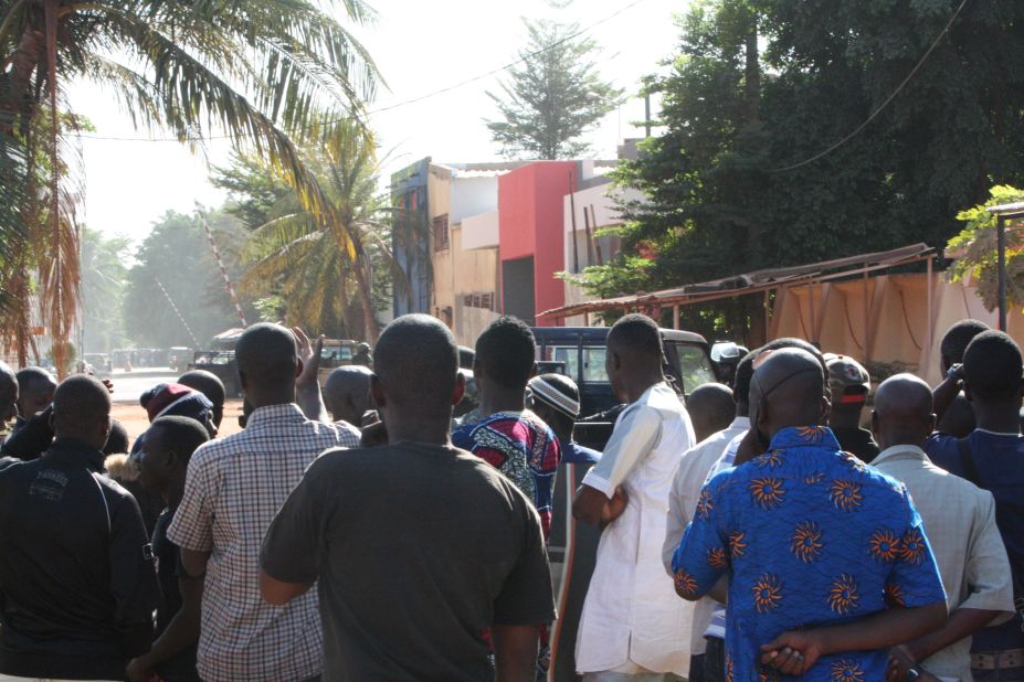 Onlookers gather near the hotel on November 20.