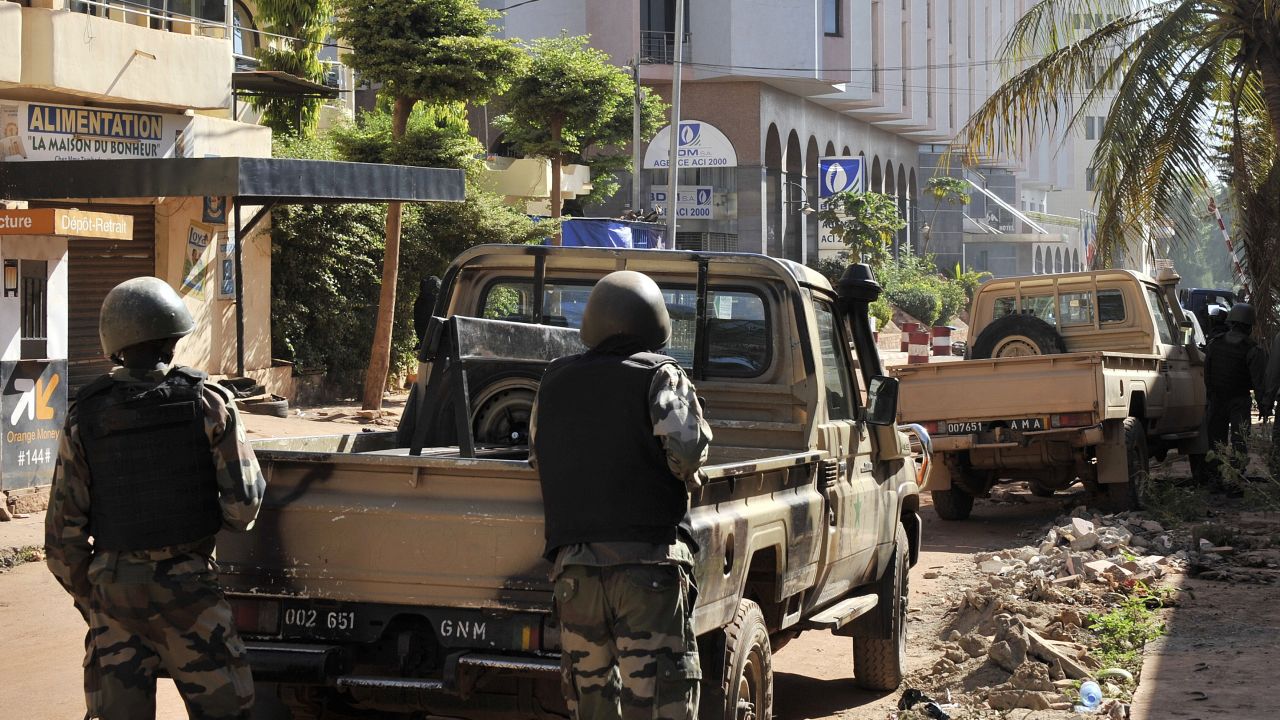Malian troops are seen outside the hotel on November 20.