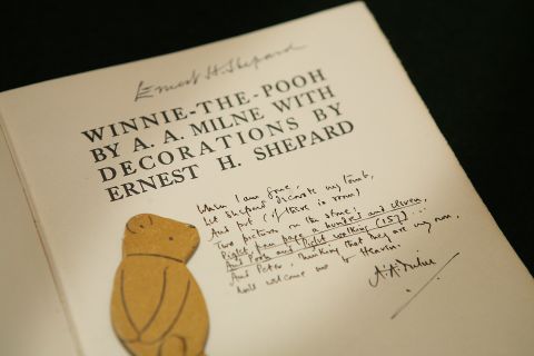 An early edition "Winnie-the-Pooh" book showing an inscription from author AA Milne asking for artist EH Shepard to decorate his tomb, is displayed at a press preview at Sotheby's Auctioneers in 2008.