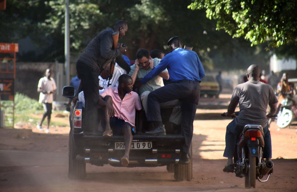 Security forces escort hostages who were freed from the Radisson Blu Hotel in Bamako, Mali, on Friday, November 20. Gunmen stormed the hotel and took 170 hostages. At least 21 deaths have been reported. No group immediately claimed responsibility for the attack.