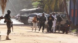 People flee from the Radisson Blu Hotel in Bamako, Mali on Friday, November 20, amid reports of a hostage situation.