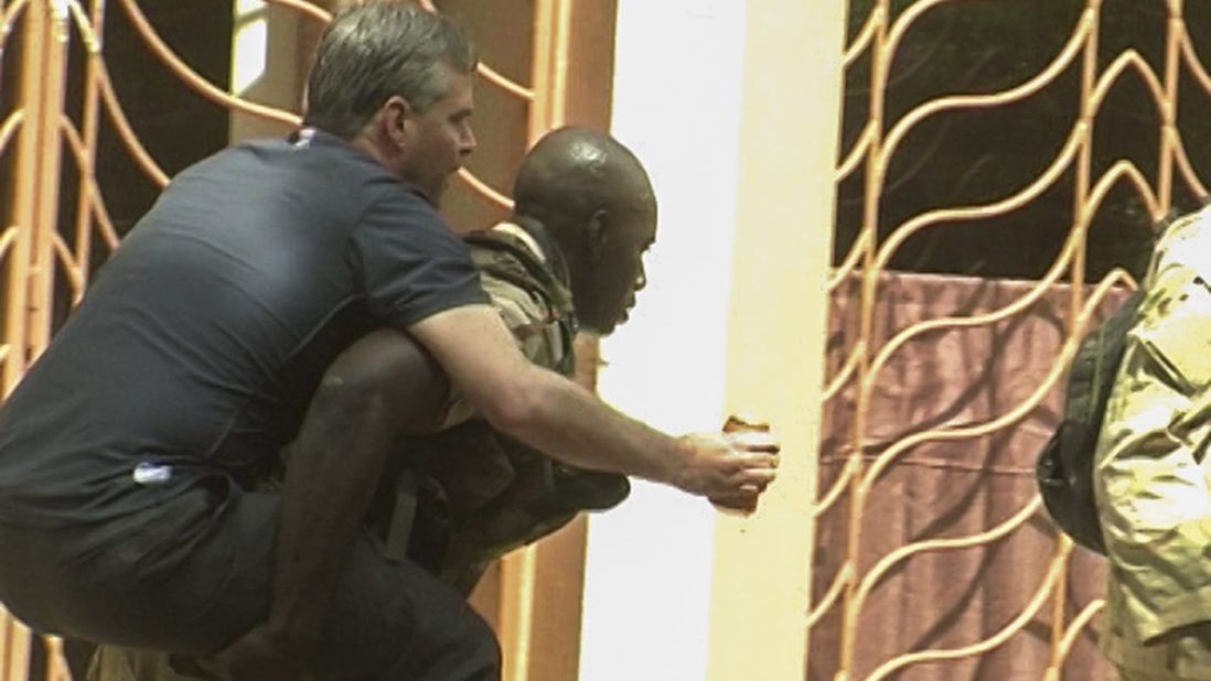 An injured, rescued hostage is carried from the hotel on November 20.