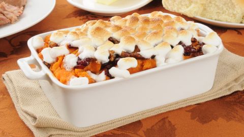 A one-cup serving of sweet potato casserole can have a whopping 460 calories. Did you really expect anything less from a marshmallow-topped dessert that masquerades as a side dish? You can halve the calories by substituting a pecan topping for the marshmallows and mixing fruit juice and honey instead of butter and sugar into the sweet potatoes.