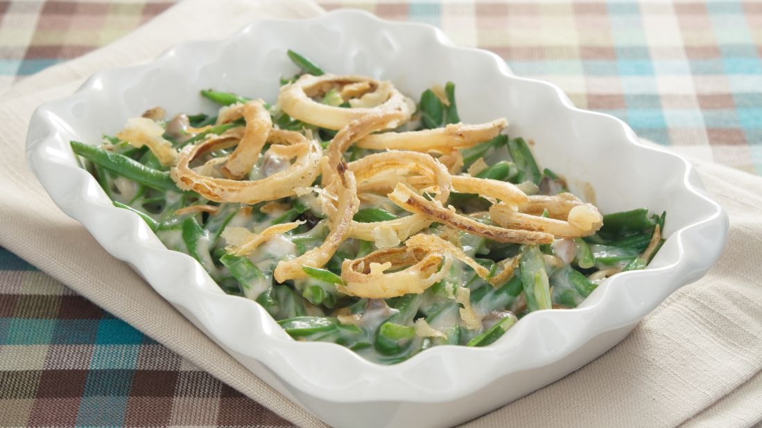 The only green vegetable at many Thanksgiving dinners, a three-quarter cup serving of green bean casserole contains 230 calories. The cream of mushroom soup, milk and crispy, fried onions in the casserole version drive up the calories.  Another version, green beans that are topped with grated Parmesan cheese, has about 50 calories.