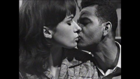 Elizabeth and Lloyd Reckord kiss in "You in Your Small Corner," in 1962.