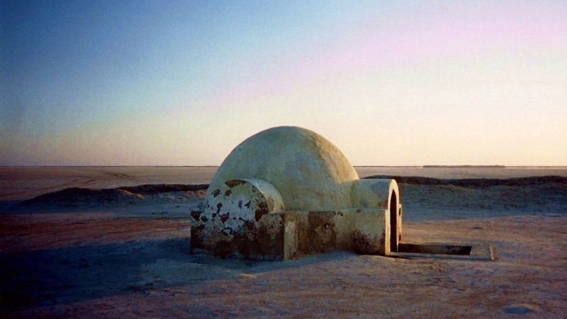 The films famously shot scenes for Tatooine in Tunisia, utilizing grain storage containers called ghorfas and turning the Sisi el Driss Hotel in Matmata into Luke's subterranean home. Pictured is the entrance to Luke's homestead, which <a href="index.php?page=&url=http%3A%2F%2Fedition.cnn.com%2Fblogarchive%2Finsidethemiddleeast.blogs.cnn.com%2F2012%2F07%2F12%2Fstar-wars-fans-restore-luke-skywalkers-tunisia-ranch%2F">fans restored in 2012</a>.