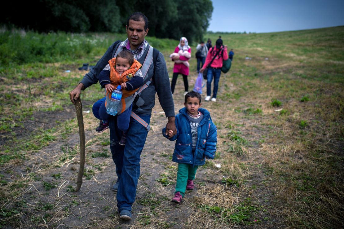 A group of migrants from Syria walk towards the border with Hungary, near the northern Serbian village of Martonos, near Kanjiza, on June 25, 2015.