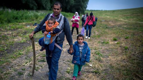 A group of migrants from Syria walk towards the border with Hungary, near the northern Serbian village of Martonos, near Kanjiza, on June 25, 2015.