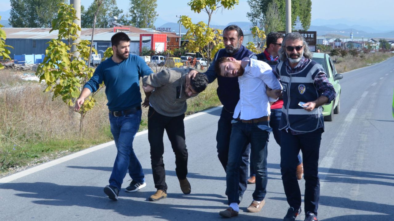 Two Syrian nationals, Ahmet Tahir, left, and Muhammed Verd, were arrested by Turkish security forces in southern Antalya province, Turkey, on November 20. They were captured, allegedly with a fake Syrian passport for Belgian national Ahmad Dahmani, suspected of location scouting for the Paris attackers.