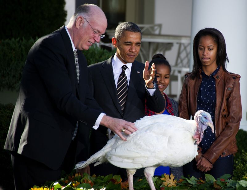 Obama gestures while pardoning a turkey in 2012.